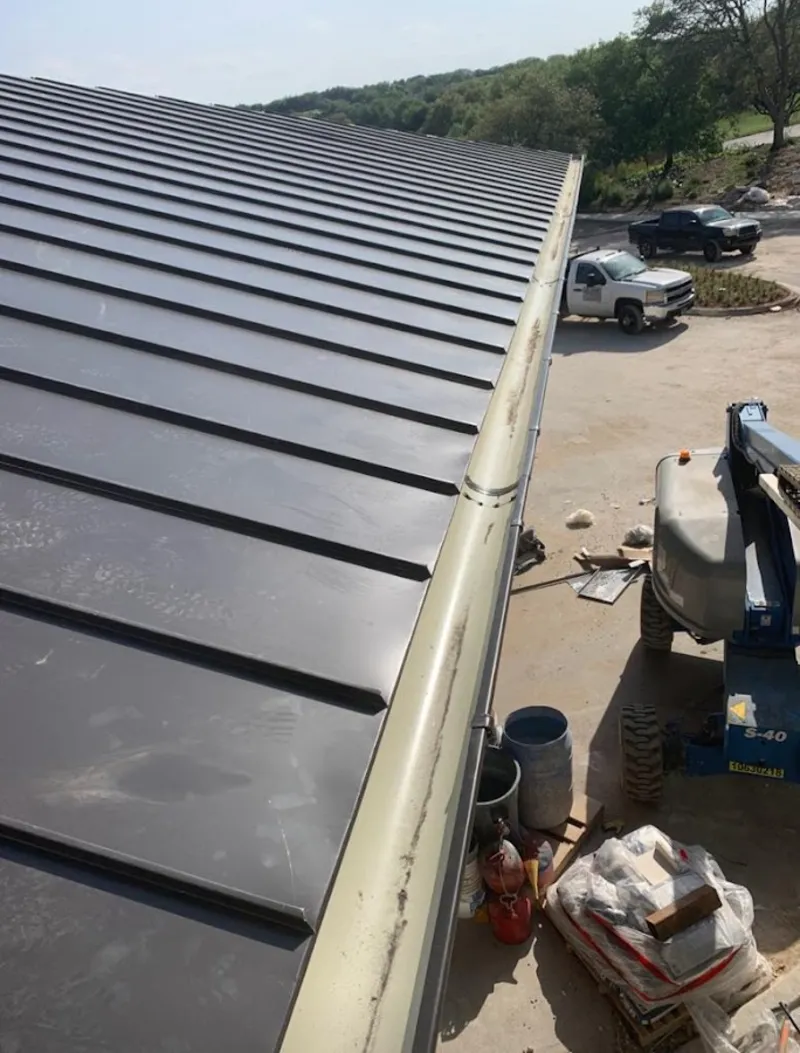 Standing seam panel and gutter detail on a metal roofing jobsite in Fairview Heights